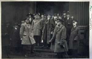 7-4-17, Witley Camp -  Dear Mother	I think they are waiting for the pictures at the court house before they took the colors away to the Bristol cathedral We are standing just back in the street. 	You see the Lord Mayor in center of doorway. Second officer to left is our colonel Two majors to right The Mayor was a good old head he come in and walked around to see and all got a good feed on Sat. dinner just after arrival. Then he gave use a good short talk. My souvenirs of the trip were lost with my haver sack but thatis nothing in war times these cards may be sunk yet by submarine,