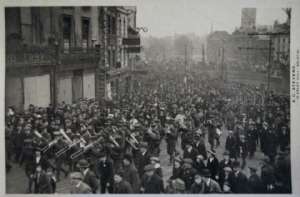 1916 Witley South Camp (4) cut down a little but there is oceans and better cooks more variety, I think it is under the imperial system some way it is an awfull change for the better any there was such an awfull waist before and now things are cleaned up. Here we are marching to the cathedral the colors are in rear of parade. You can see a streamer in the river and the bridge in the rear. I have put a mark over the colonel there is quite a crowd on the street as you can see. I only received two letters this week but I haven’t got them both answered yet so I guess that was enough. I can’t write like I did a while ago we need a move to starte me again.